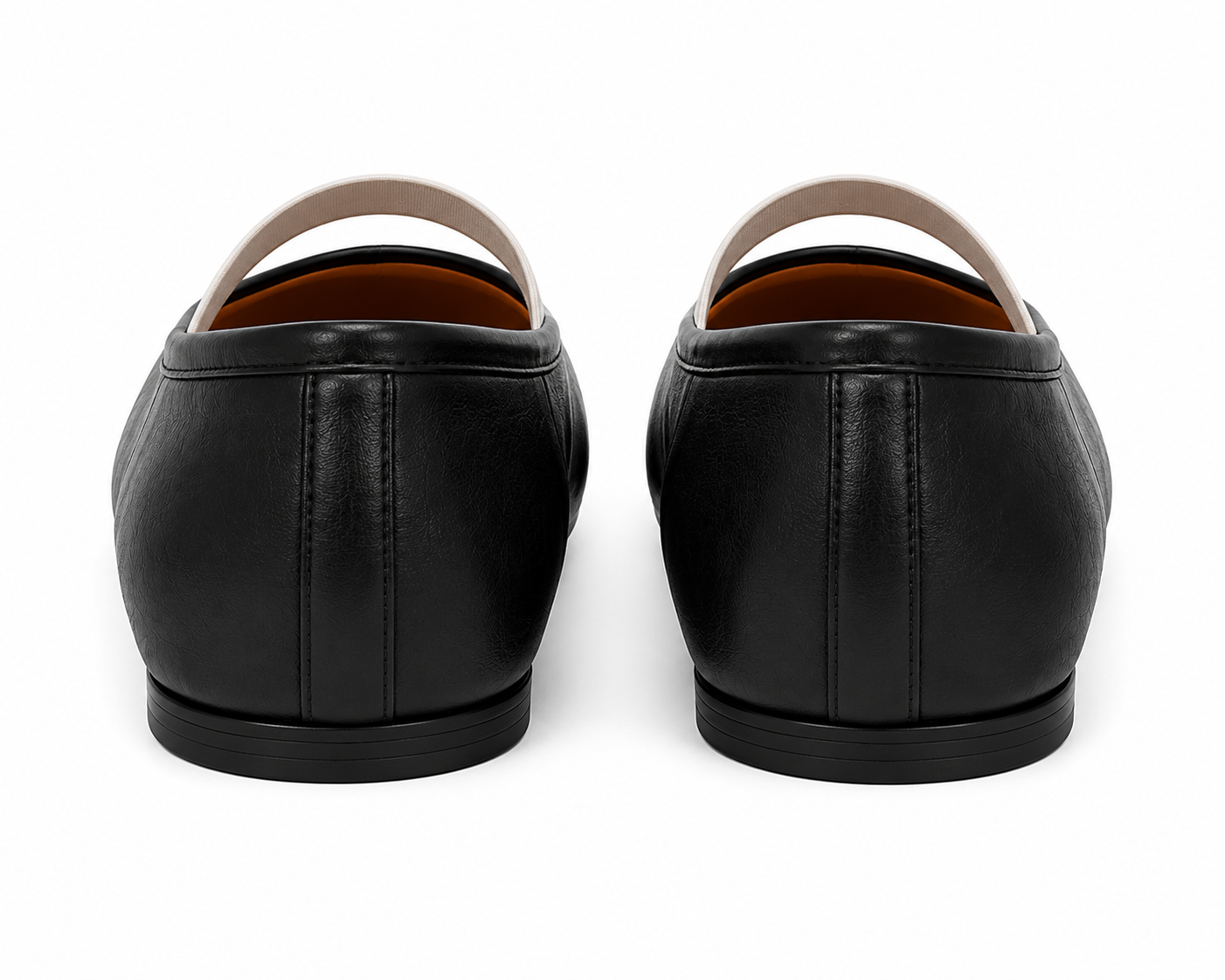 A pair of black leather slip-on shoes shown from the back, featuring a smooth leather upper, a light beige strap, and a black sole, set against a plain white background.