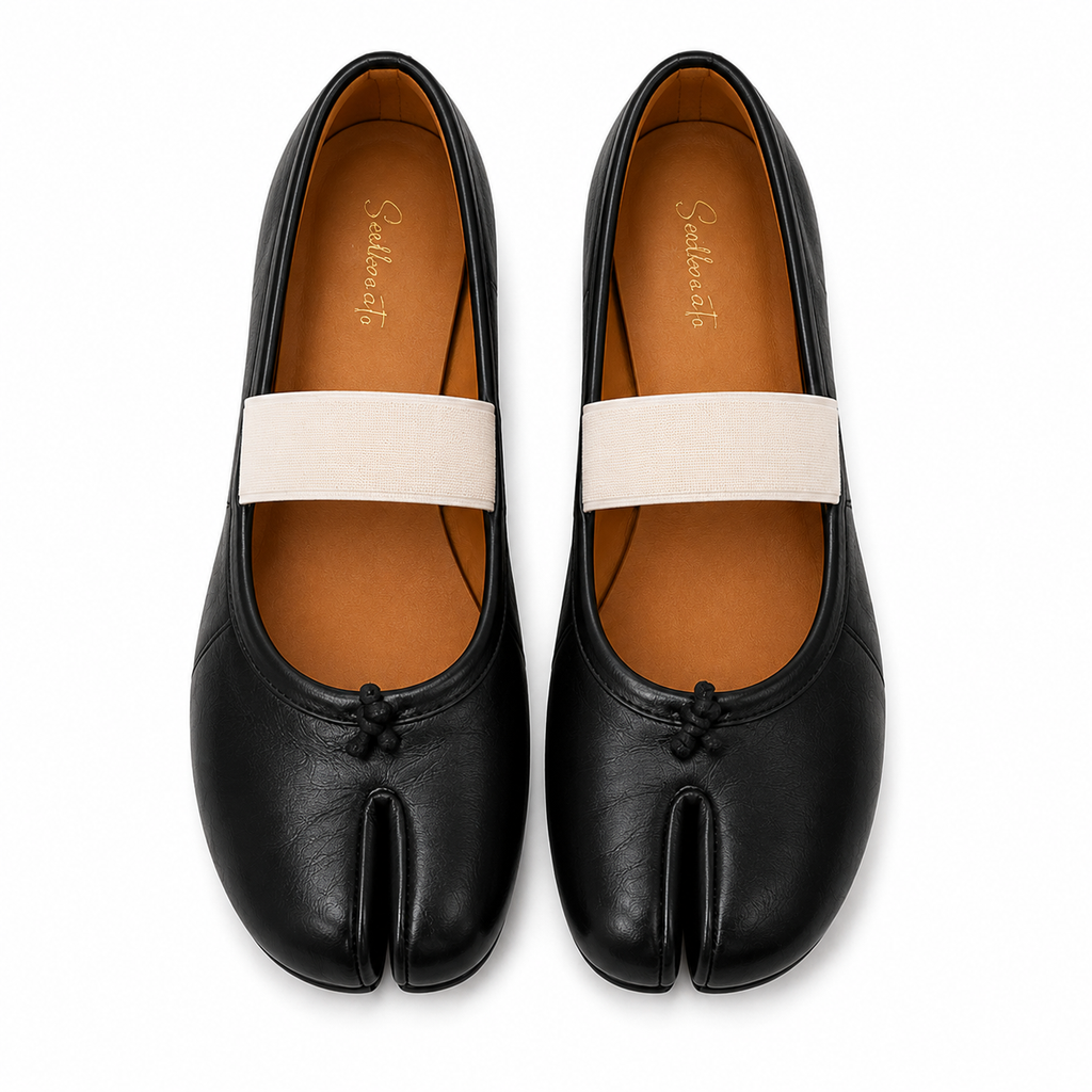 A pair of black leather tabi-style flats with a wide off-white elastic band across the top and a small black tab detail at the toe, shown from a top-down view on a white background.